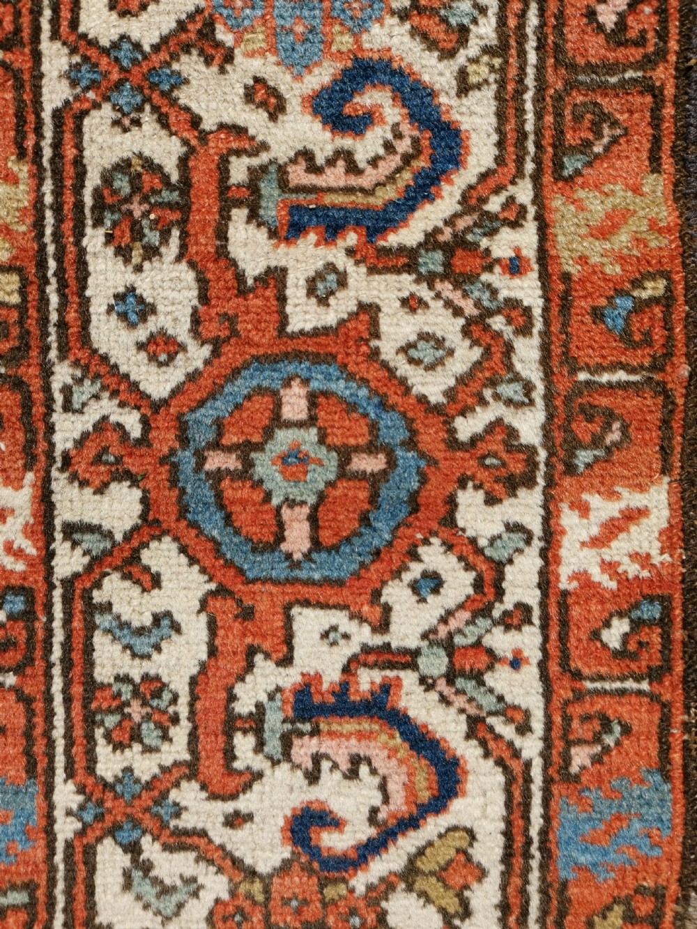 Hand-knotted antique Persian Karaja rug featuring a navy blue field with geometric diamond medallions, framed by multi-coloured decorative borders. View II