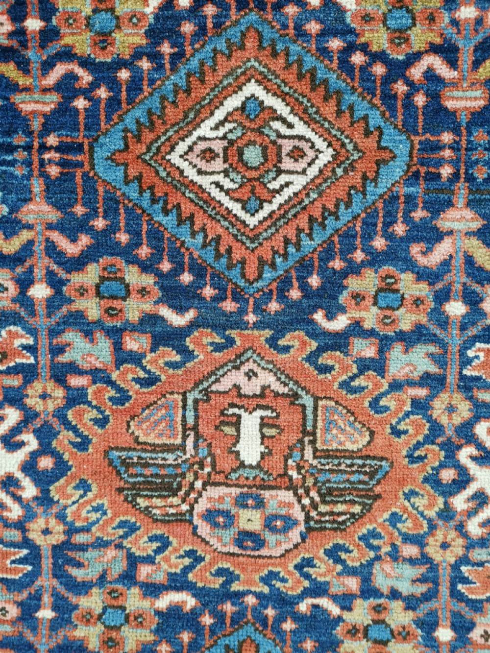 Hand-knotted antique Persian Karaja rug featuring a navy blue field with geometric diamond medallions, framed by multi-coloured decorative borders. View IV