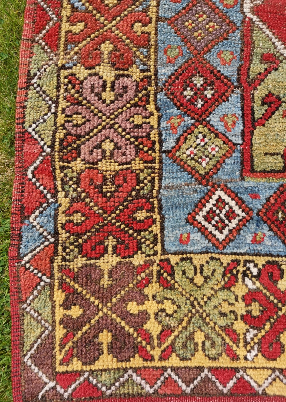 A hand-knotted antique Anatolian Konya prayer rug featuring a red mihrab arch motif, central tree pattern, and geometric multi-coloured borders. View II