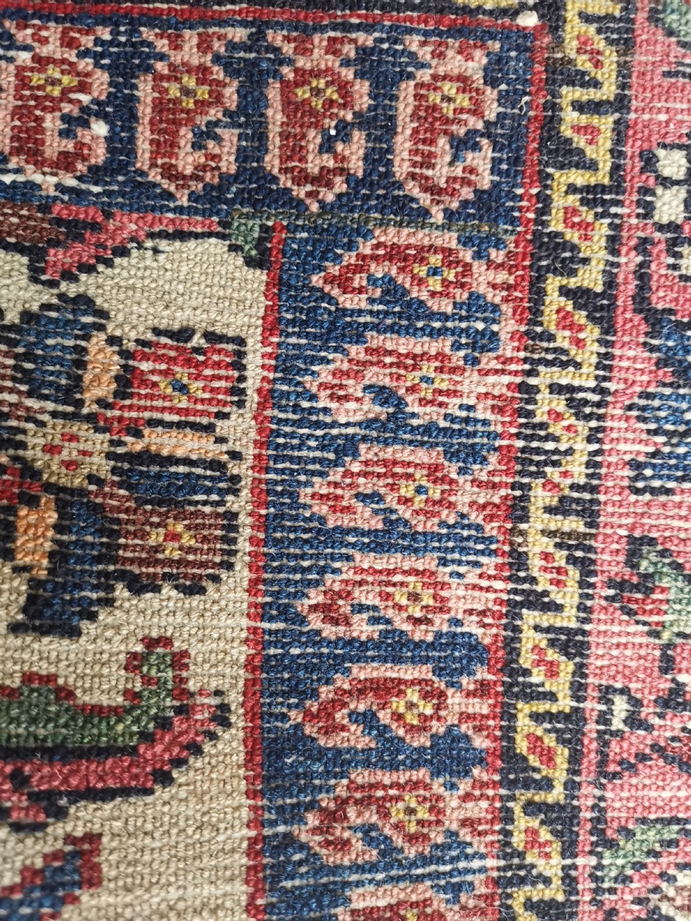 A hand-knotted antique Persian Tafresh wool rug featuring a deep navy blue field, a prominent rose pink central medallion, ornate floral spandrels, and bird motifs. View IV