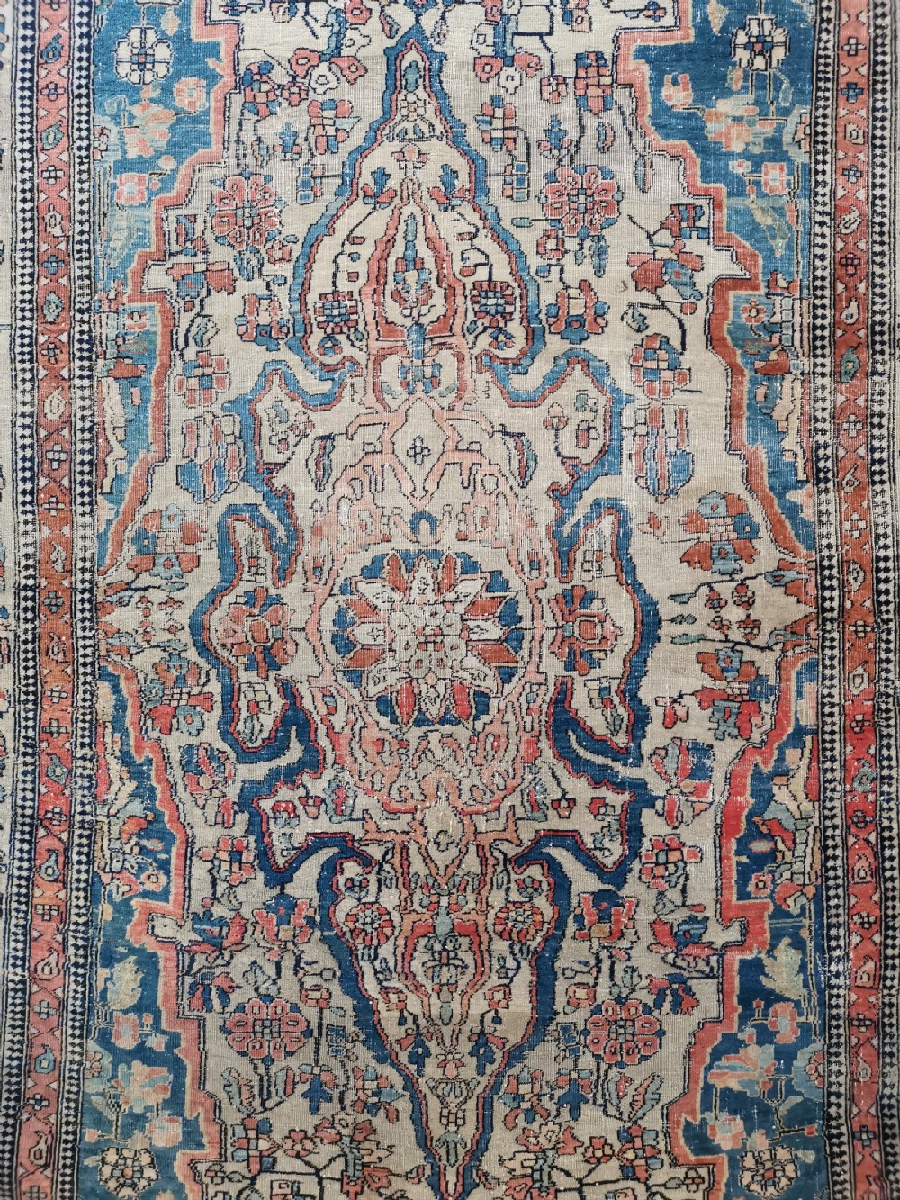 An antique hand-knotted Kashan Persian rug featuring a central blue medallion on a cream field with detailed floral borders. View II