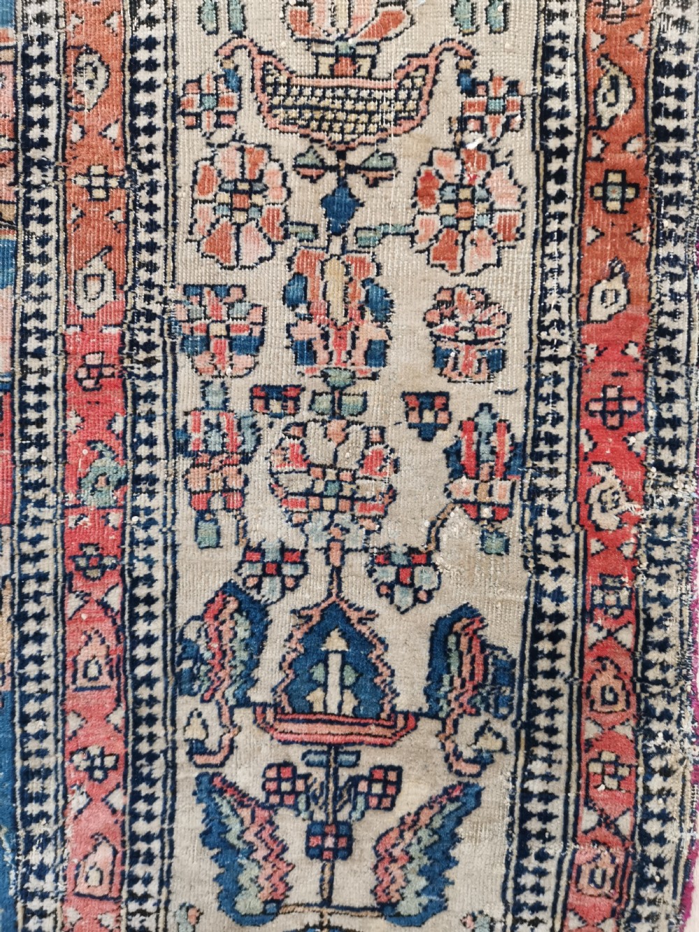 An antique hand-knotted Kashan Persian rug featuring a central blue medallion on a cream field with detailed floral borders. View IV