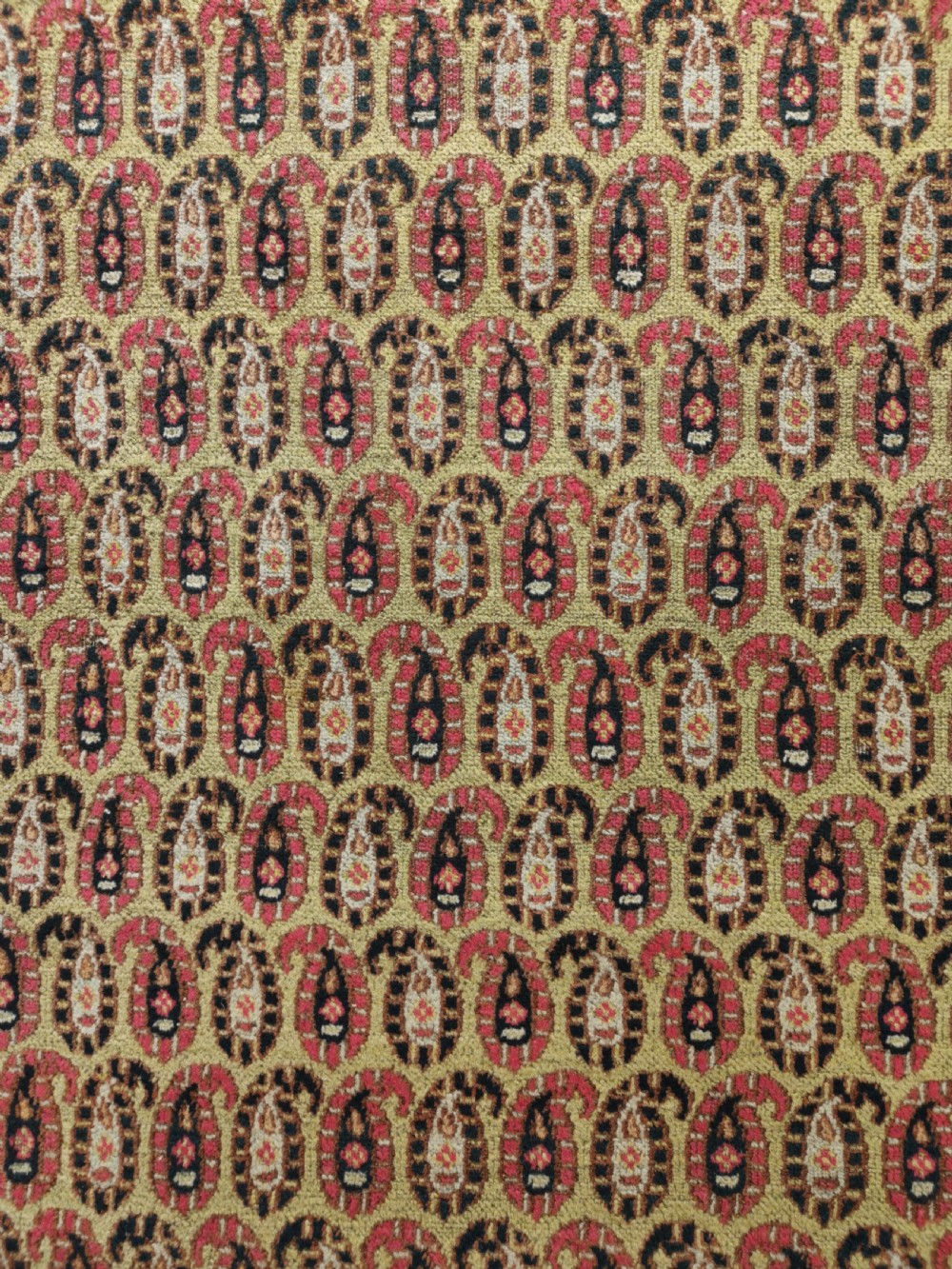 A rectangular hand-knotted Khorassan rug featuring a repeating red boteh pattern on a light yellow field, bordered by a dark floral rosette frame. View III