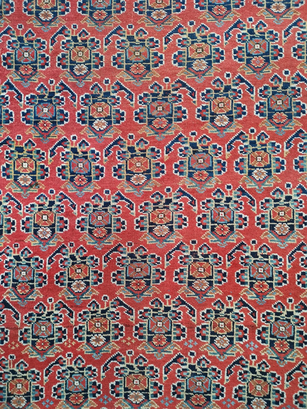 An antique hand-knotted Persian Afshar wool rug featuring a repeating geometric pattern on a deep red field framed by multi-banded borders and flat-woven ends. View II