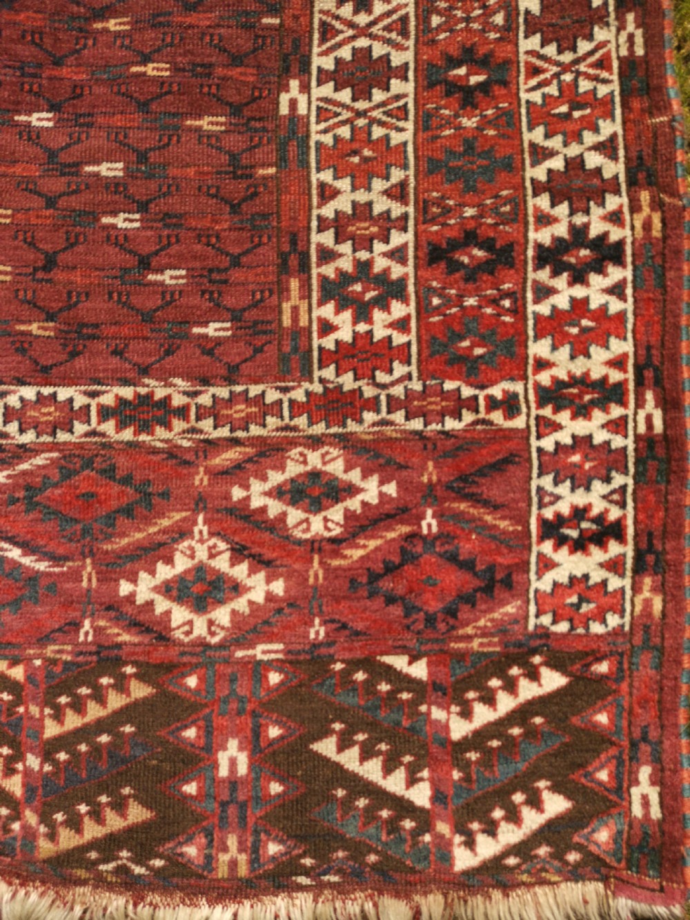 A hand-knotted dark red Yomud Engsi wool rug featuring a cruciform central pattern, geometric borders, and a patterned lower elem skirt. View II