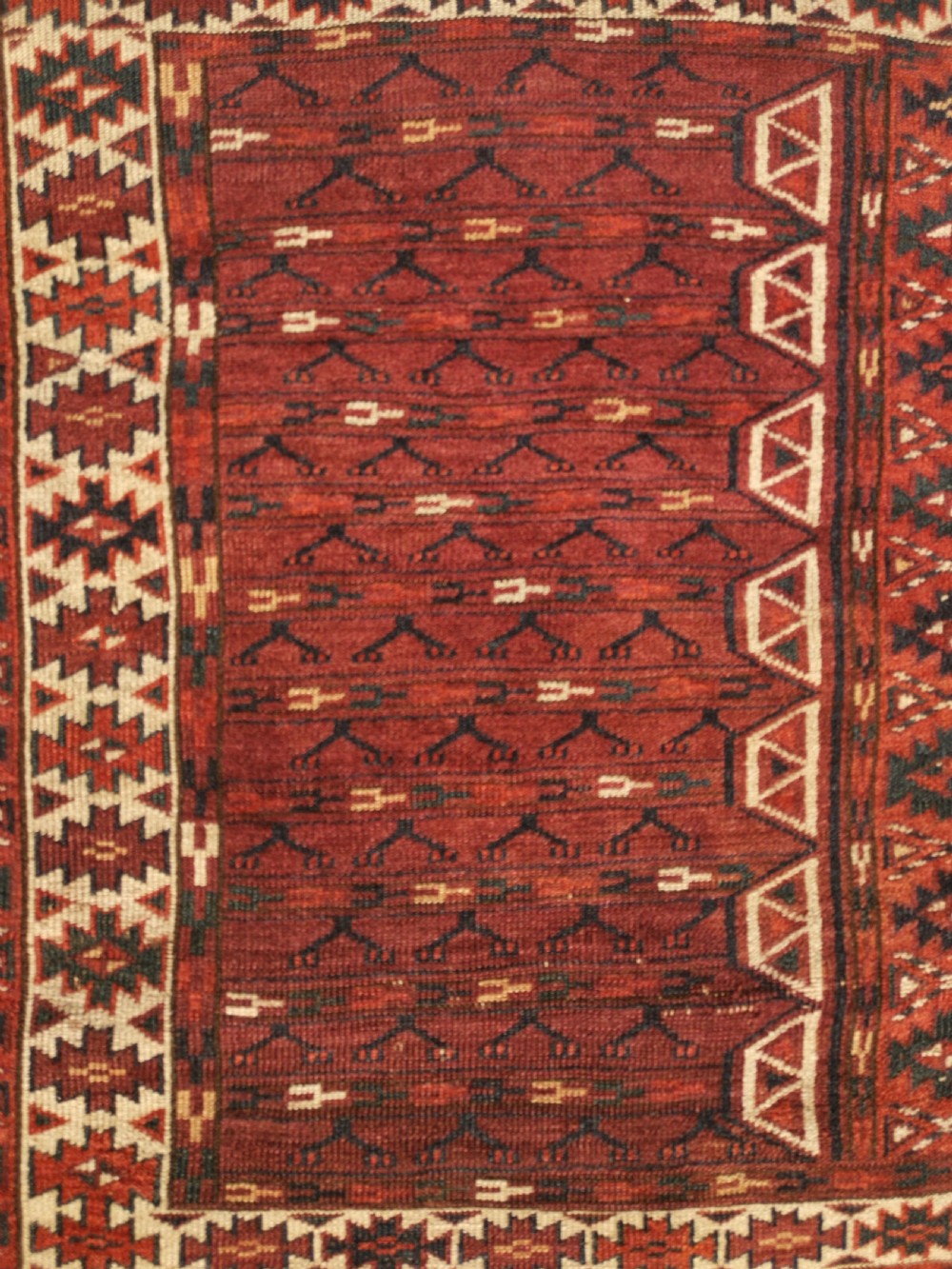 A hand-knotted dark red Yomud Engsi wool rug featuring a cruciform central pattern, geometric borders, and a patterned lower elem skirt. View IV