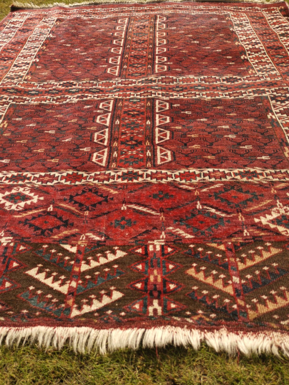 A hand-knotted dark red Yomud Engsi wool rug featuring a cruciform central pattern, geometric borders, and a patterned lower elem skirt. View V
