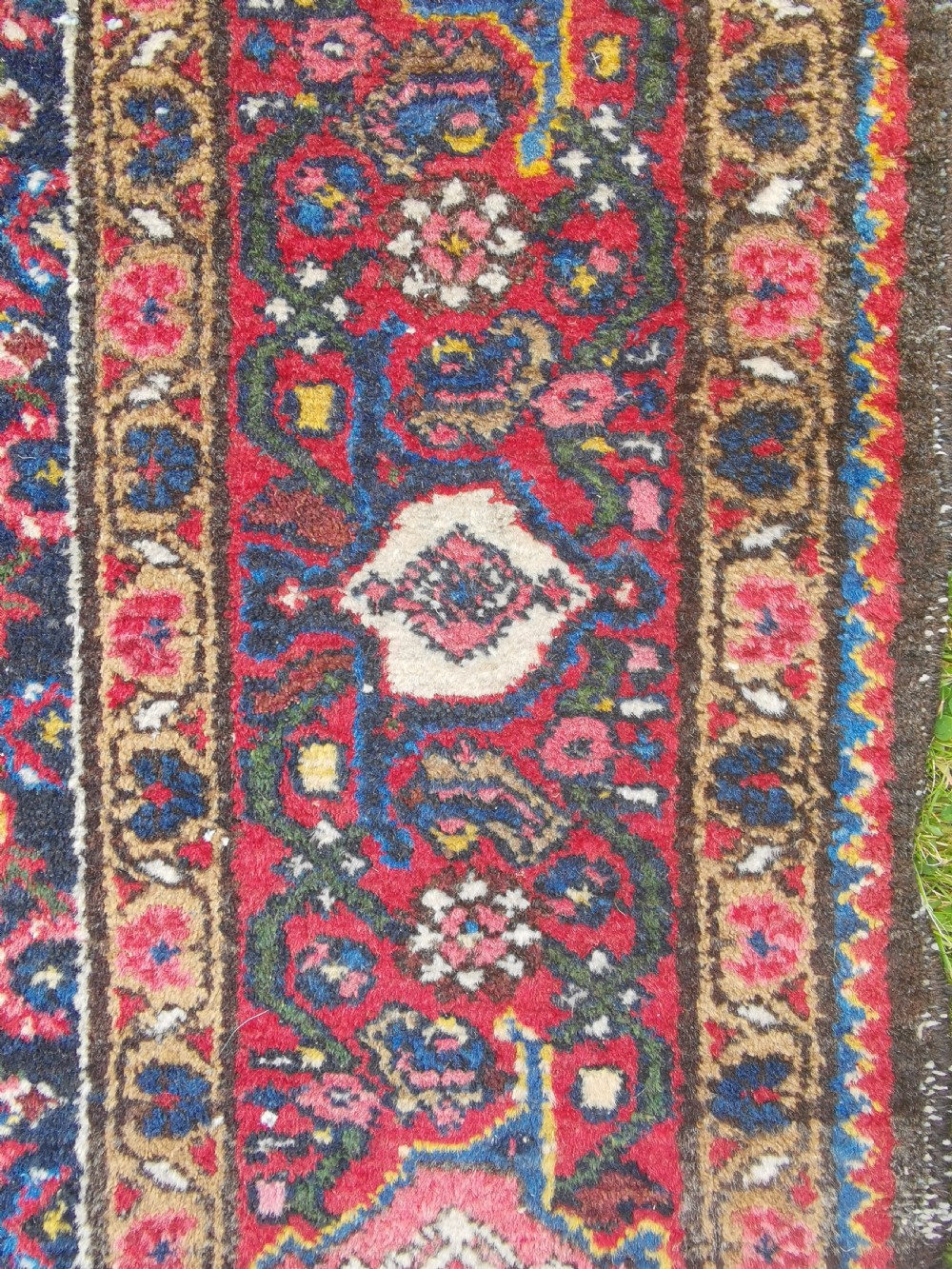 A hand-knotted Persian Hamadan wool rug featuring a central red and blue diamond medallion set on an indigo floral field with a red geometric border. View II