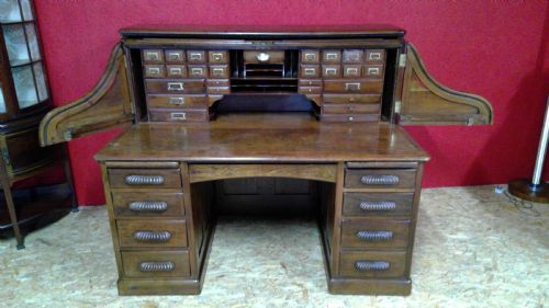 rare  arvion roll top desk with  walnut raised  fielded  chamfered panels of impressive size with unusual flap opening side wings fitted 