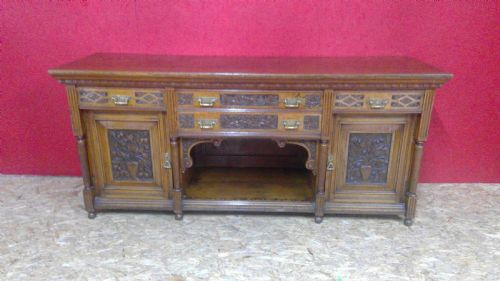 lambs of manchester quality,a large impressive and robust pollard burr oak arts and crafts  carved panel sideboard,in the manner of designer  bruce talbert