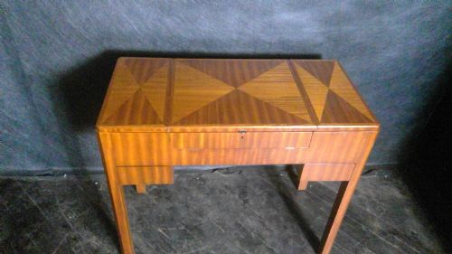 a rare and unusual  art deco period elegant  ladies metamorphic  writing table with many fitted compartments and paper envelope slots,the whole decorated in veneered geo metric patterns of fine quality