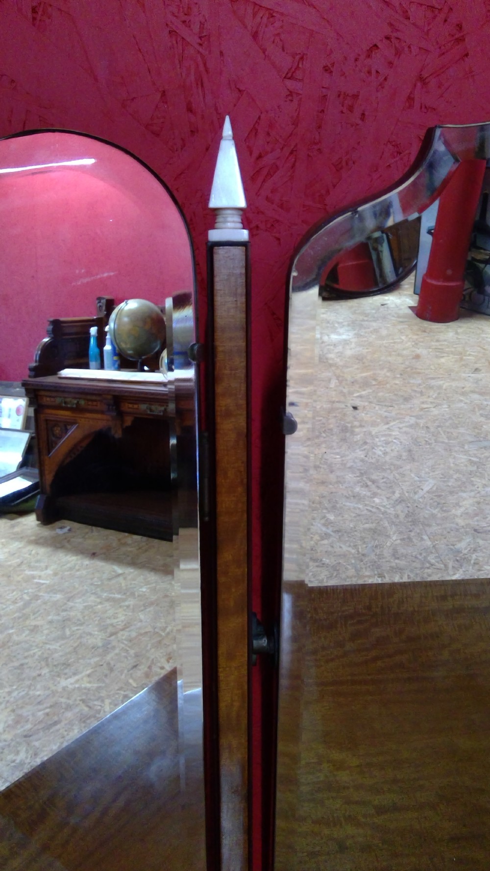 An Art Deco mahogany dressing table featuring a central mirror flanked by two adjustable wing mirrors, geometric wood inlays, and small white drawer knobs. View VIII