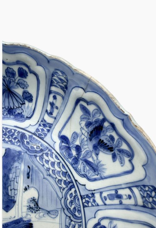 An antique Chinese Kraak porcelain dish featuring underglaze cobalt blue decoration, a central roundel with waterfowl, and a lobed border with radiating panels. View V