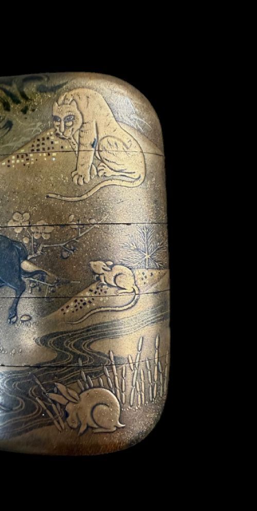 A multi-tiered Japanese gold maki-e lacquer inro featuring detailed relief depictions of zodiac animals including an ox, rabbit, rat, snake, and tiger. View IV