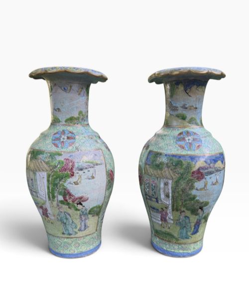 fig 1. A pair of 19th-century Chinese Yixing stoneware baluster vases decorated in vibrant polychrome enamels with figural panels on a patterned green ground.