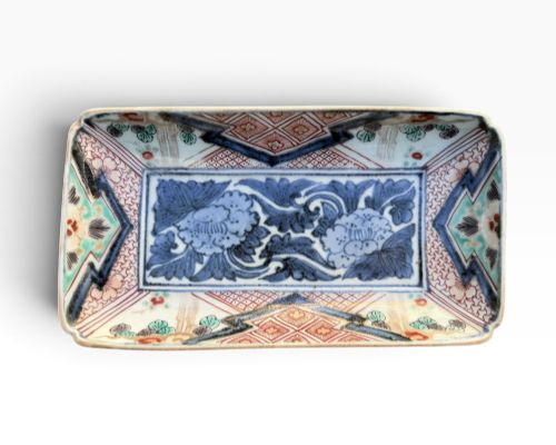 fig 1. A pair of rectangular Japanese Imari porcelain dishes decorated with central blue floral panels and geometric diaper borders.