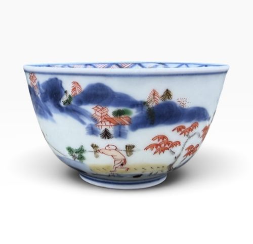 fig 1. A small Japanese porcelain teabowl decorated with hand-painted figures, foliage, and landscapes in blue, red, green, and yellow enamels.