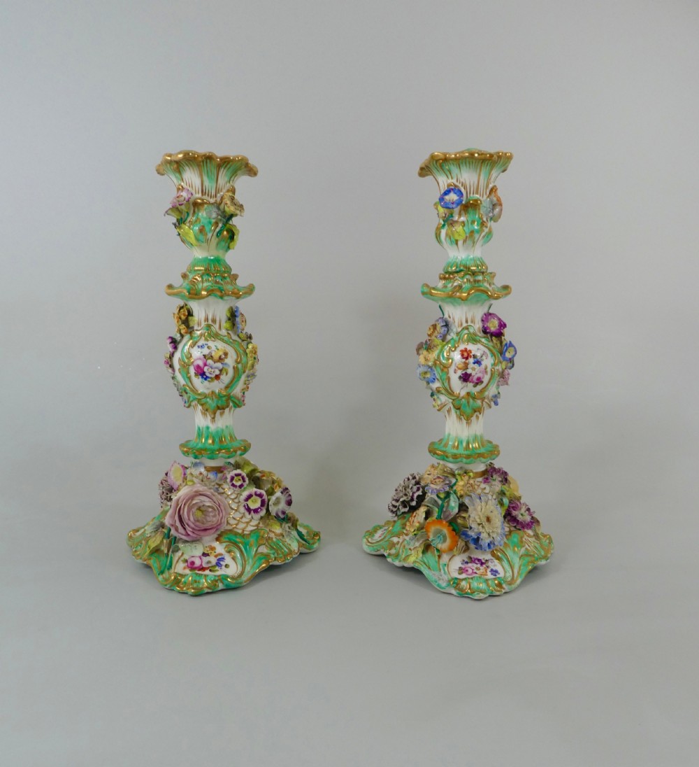 Pair Coalport flower encrusted porcelain candlesticks, c. 1830.