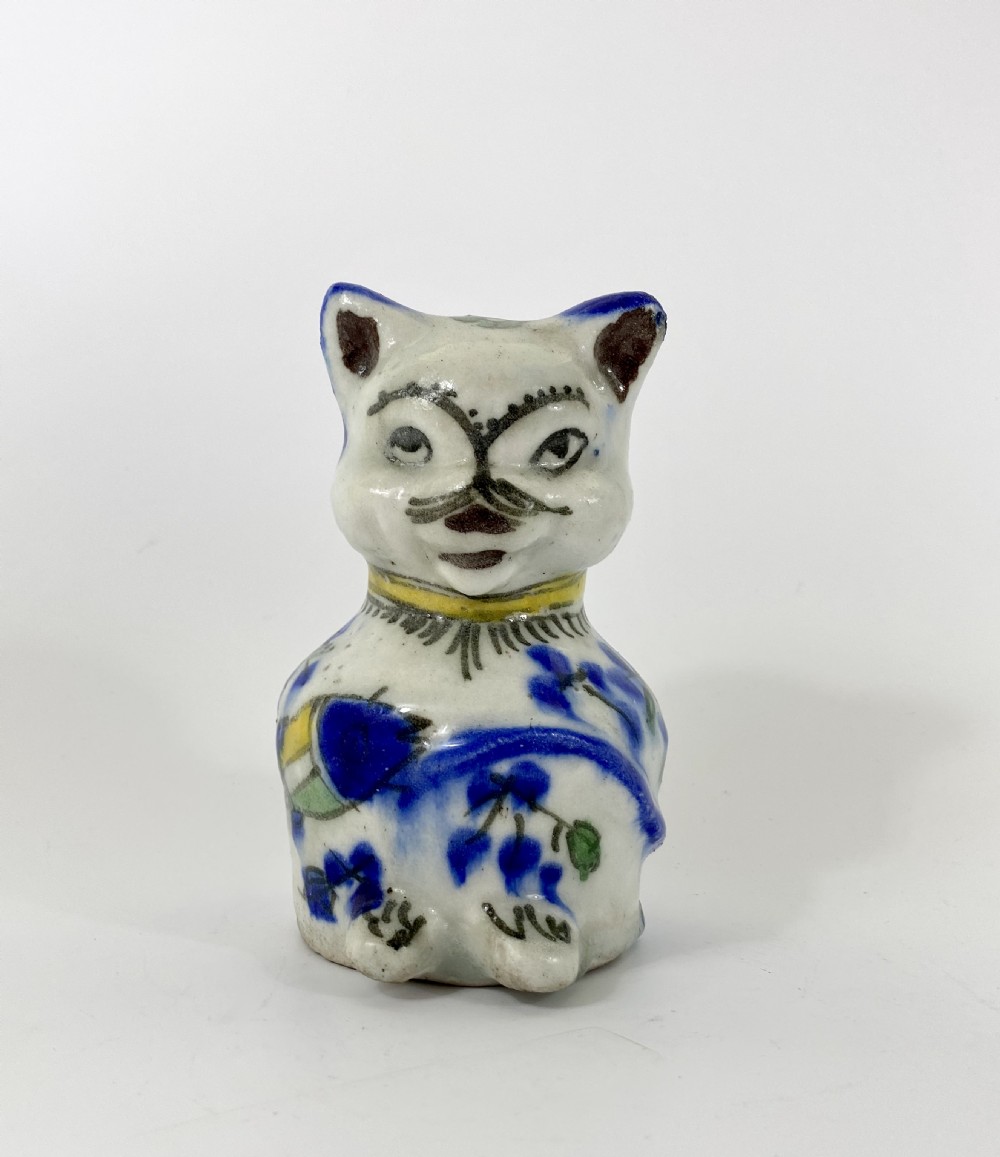 Qajar pottery seated cat. Iran, c. 1890.