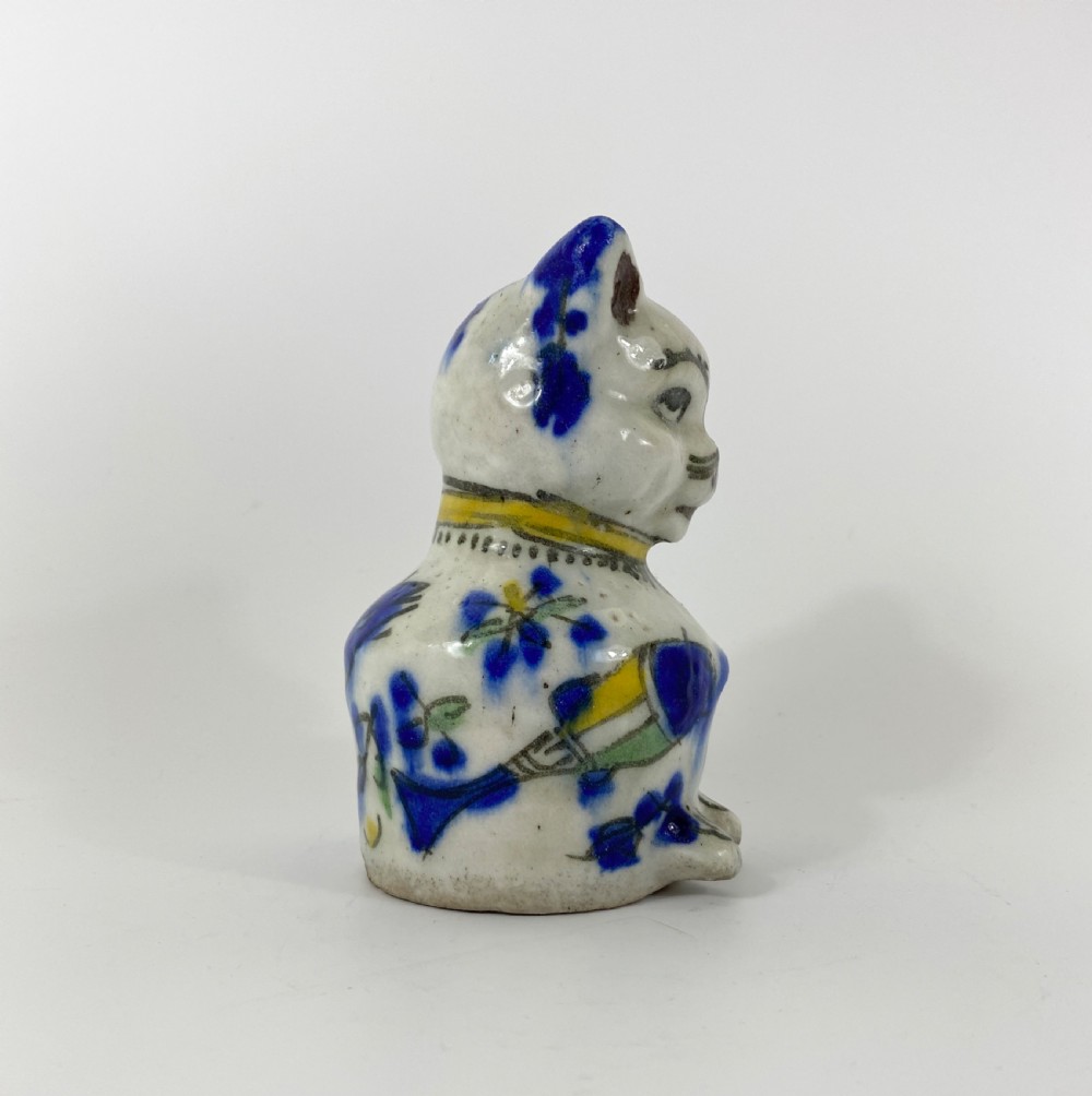 Qajar pottery seated cat. Iran, c. 1890. View II