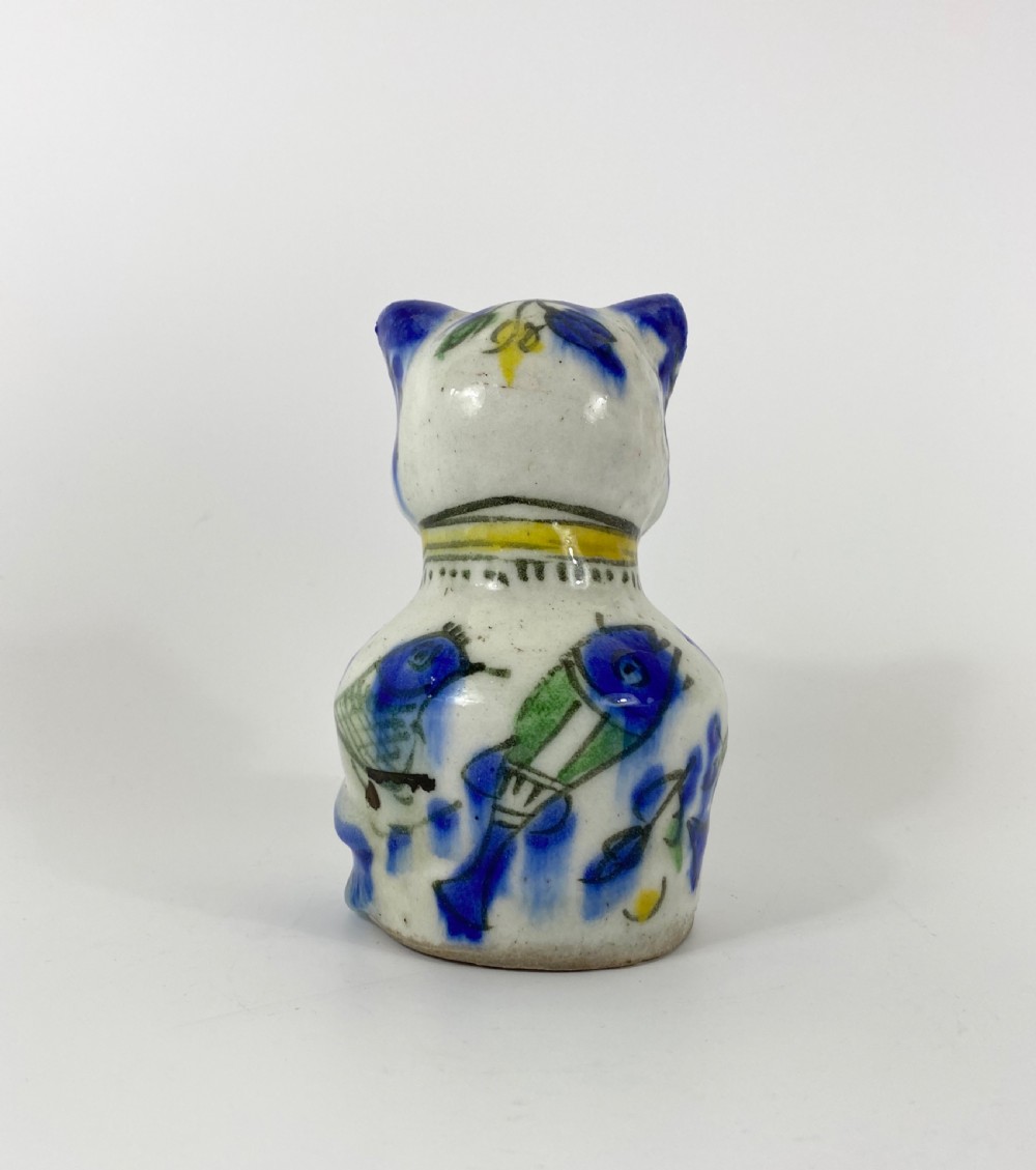 Qajar pottery seated cat. Iran, c. 1890. View III