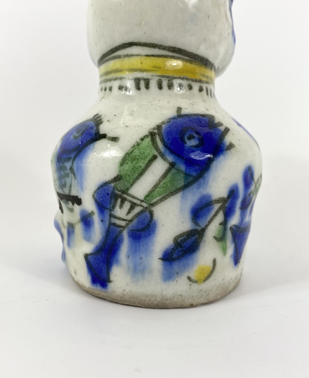 Qajar pottery seated cat. Iran, c. 1890. View VI