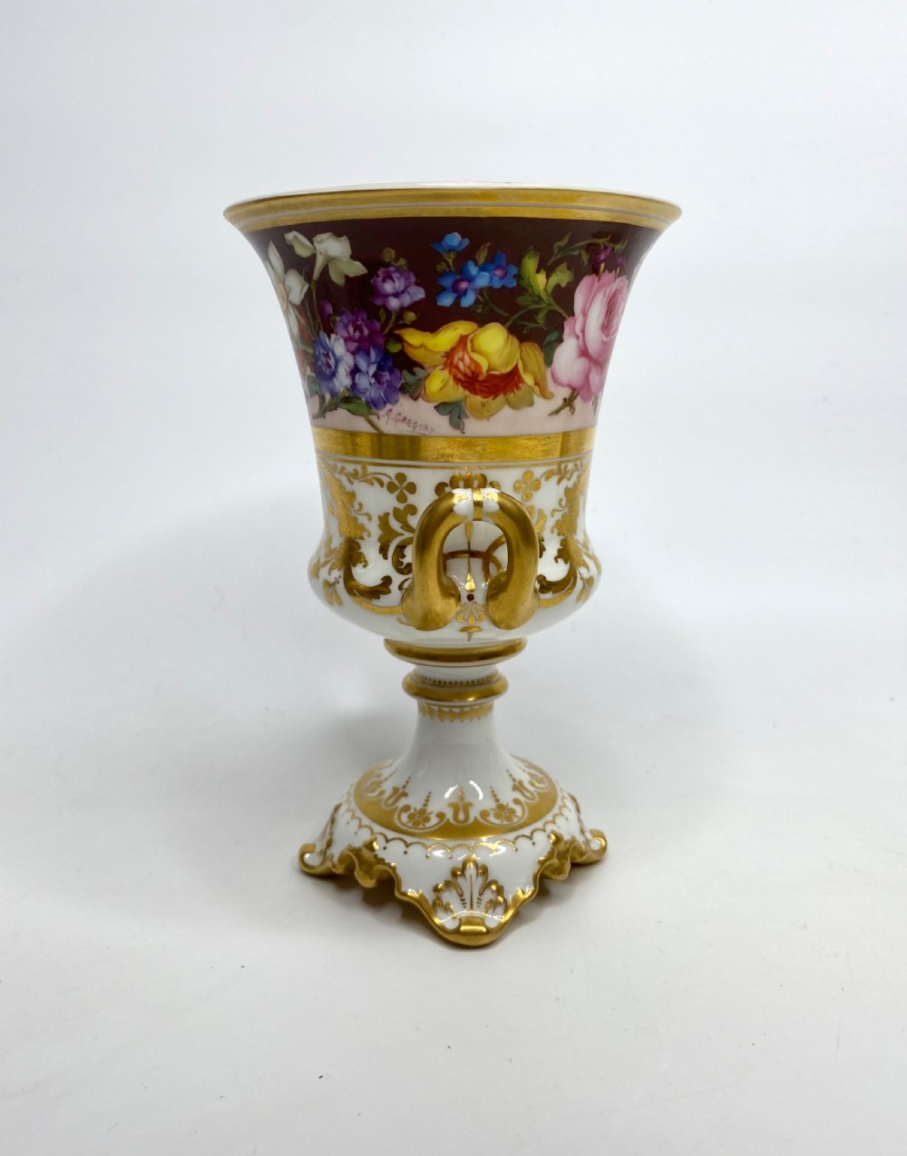 A pair of Royal Crown Derby porcelain urns featuring elaborate gold scrollwork and detailed hand-painted floral bands. View V