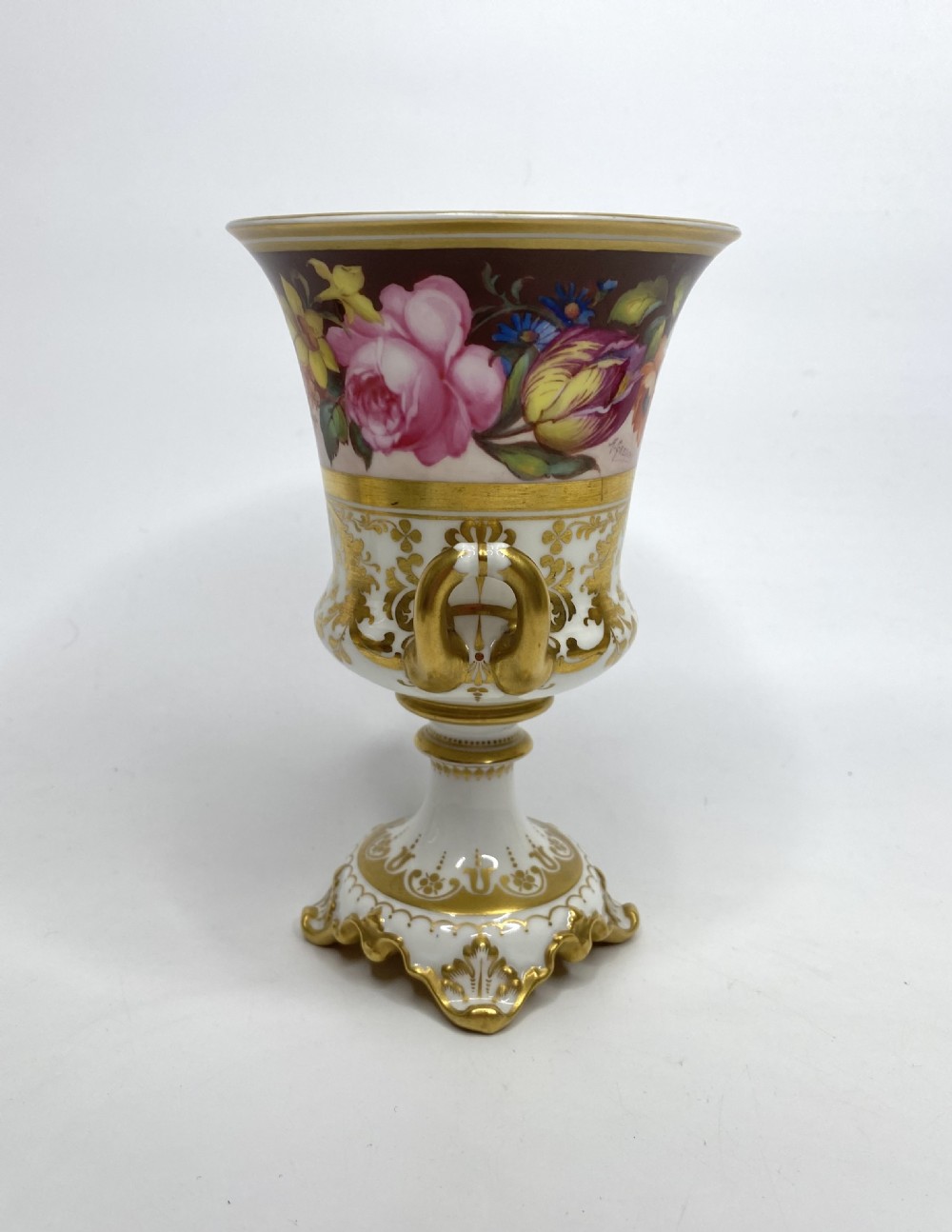 A pair of Royal Crown Derby porcelain urns featuring elaborate gold scrollwork and detailed hand-painted floral bands. View X