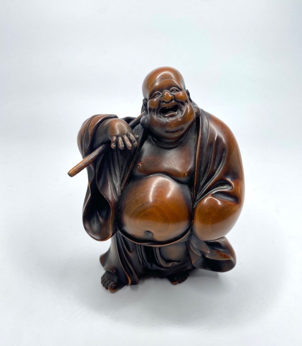 Hotei, a boxwood carved okimono, Meiji Period.