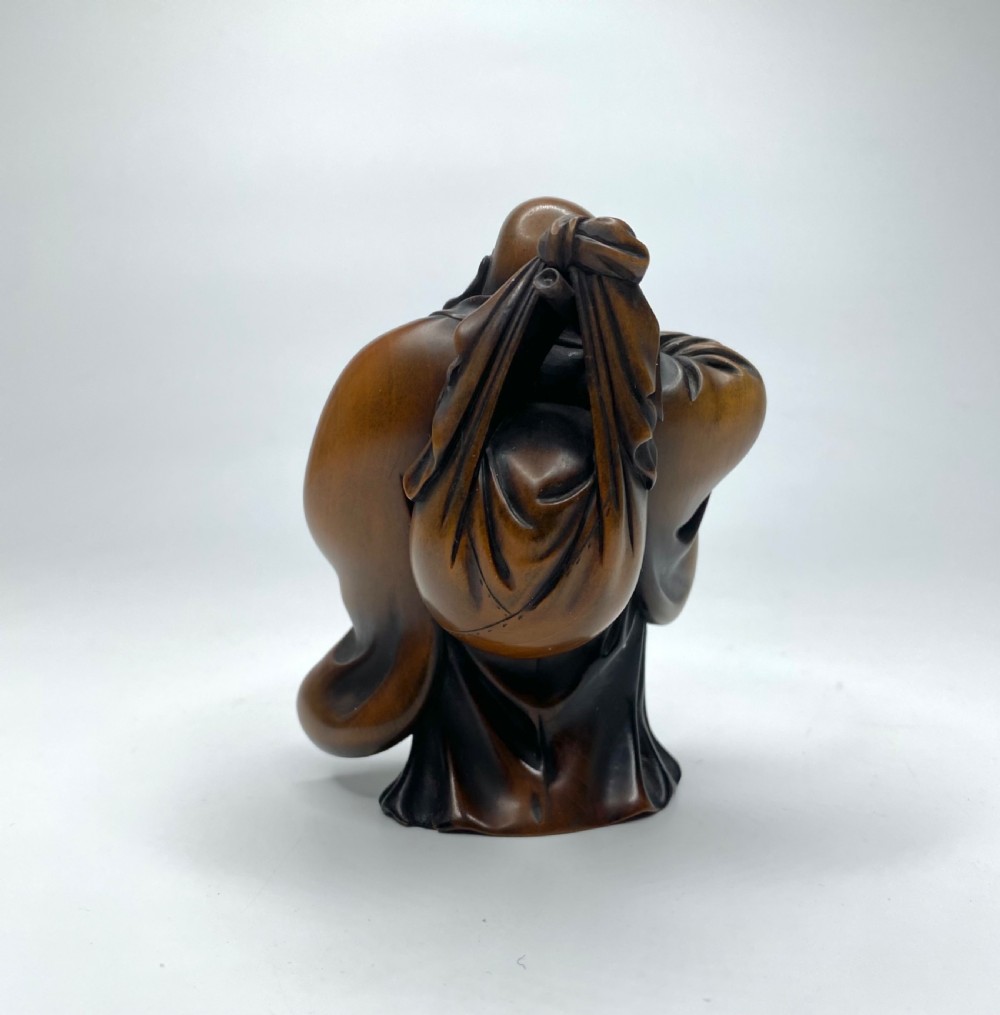 Hotei, a boxwood carved okimono, Meiji Period. View III
