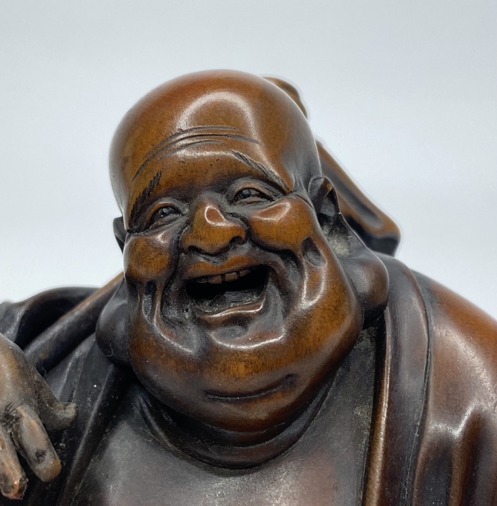 Hotei, a boxwood carved okimono, Meiji Period. View VII