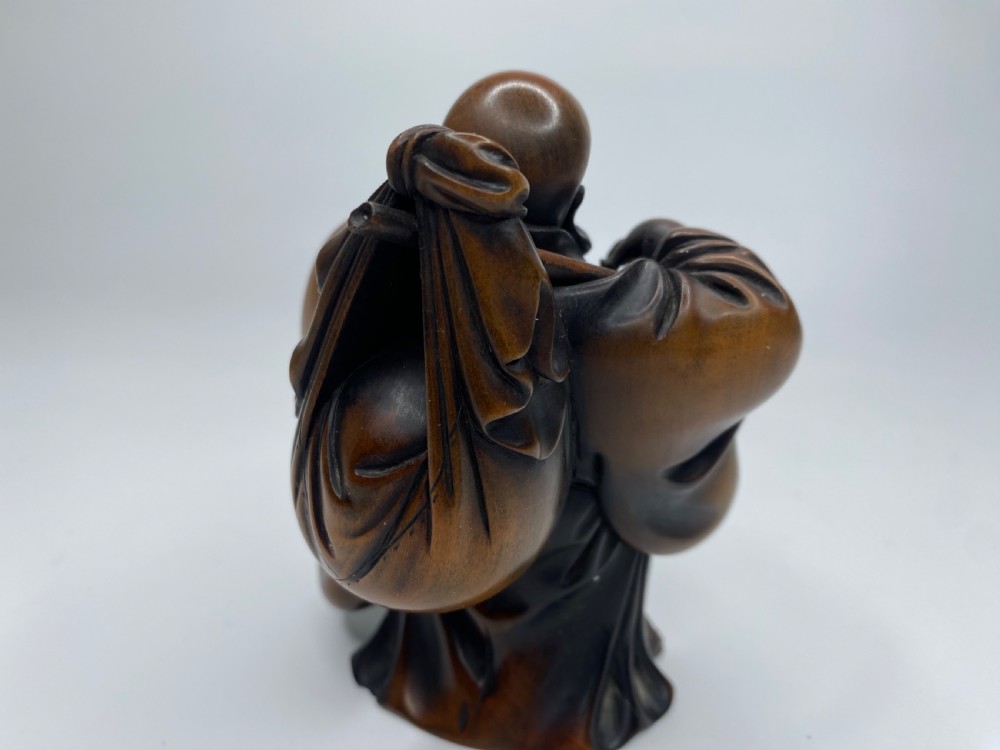 Hotei, a boxwood carved okimono, Meiji Period. View XII