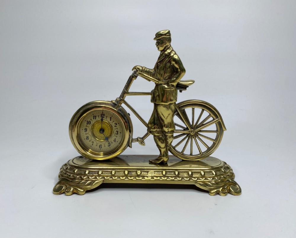 Brass cyclist and bicycle clock, England, c. 1910.