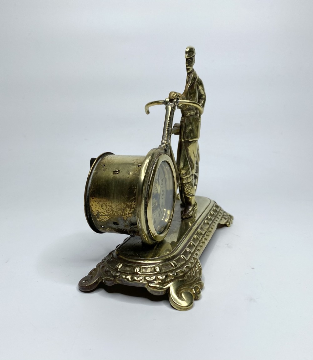 Brass cyclist and bicycle clock, England, c. 1910. View II