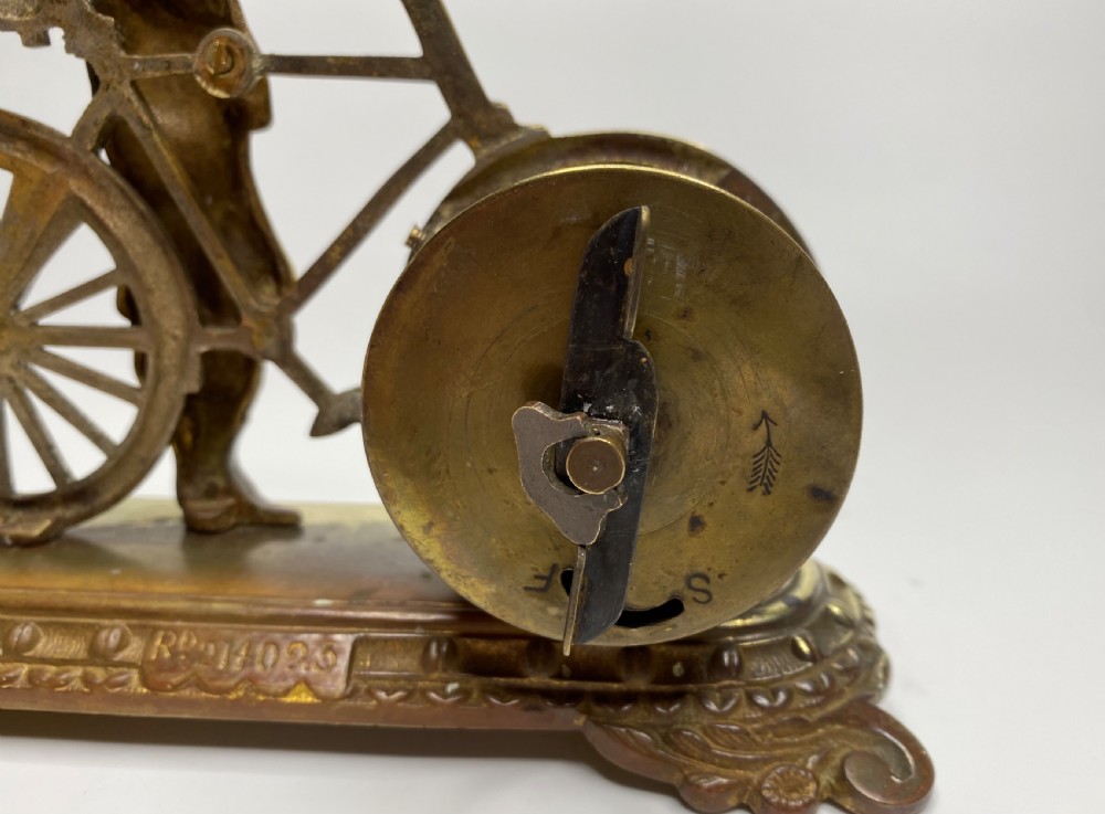 Brass cyclist and bicycle clock, England, c. 1910. View IX