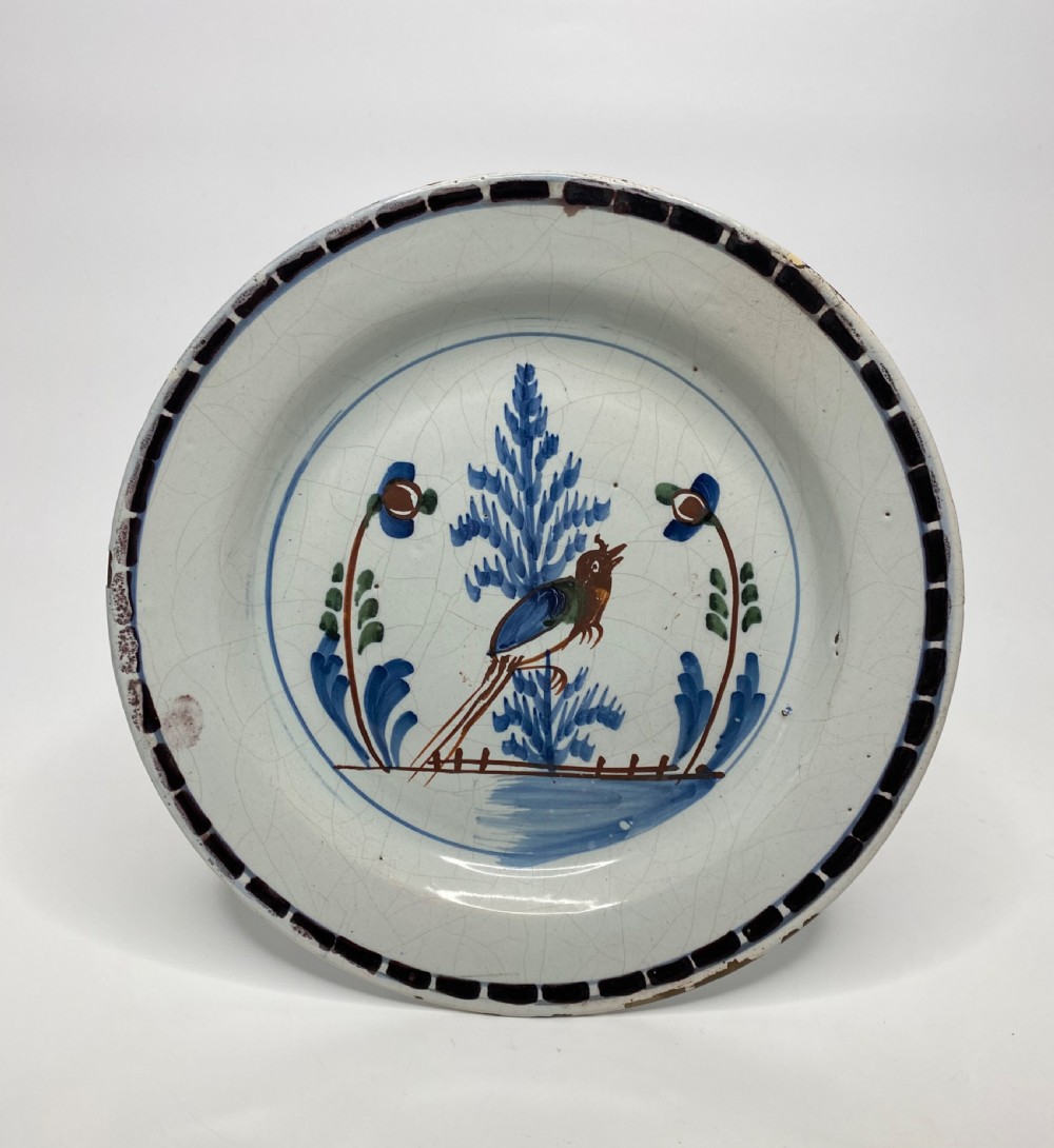 Rare London Delft pancake plate, Long tailed bird, c. 1750.