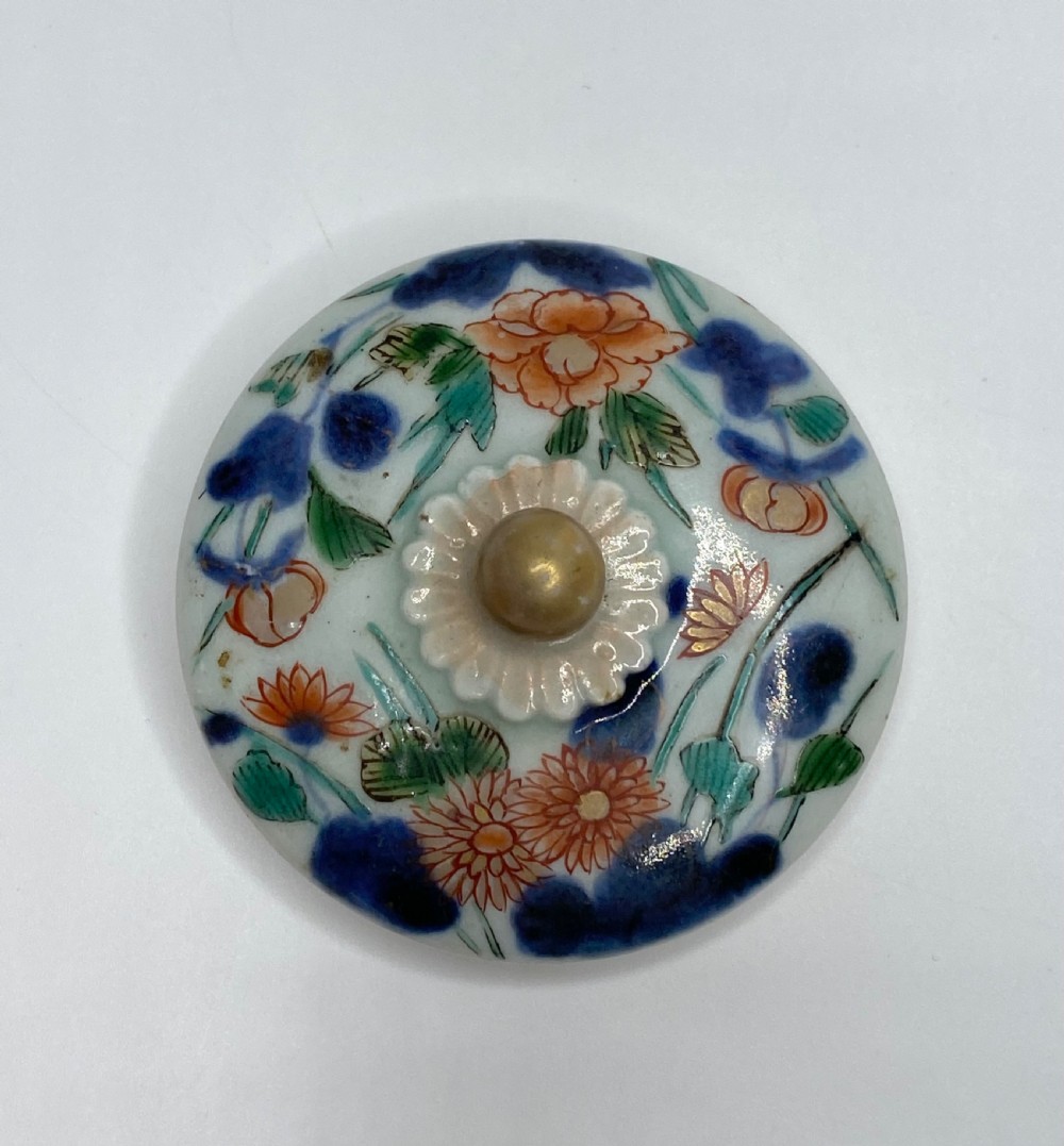 An Edo-period Japanese Imari porcelain sake ewer featuring polychrome floral enamel patterns, an overhead handle, and metal mounts. View XVIII