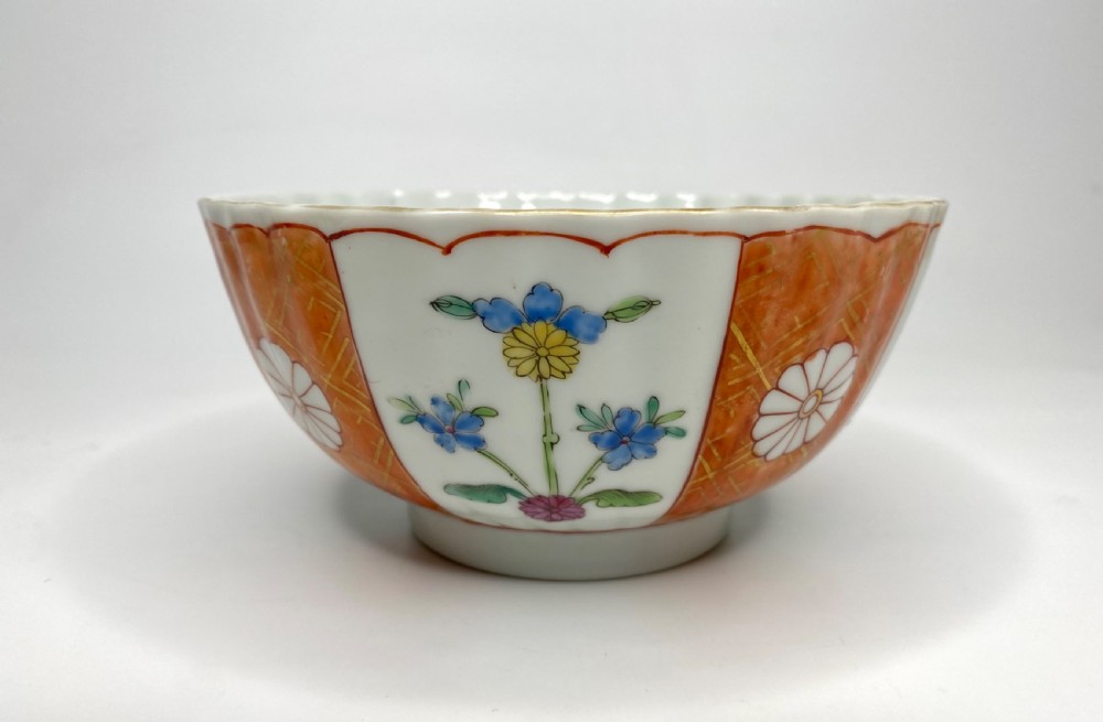 A fluted 18th-century Chinese porcelain bowl decorated in London with alternating panels of orange diaper work and hand-painted figures. View V