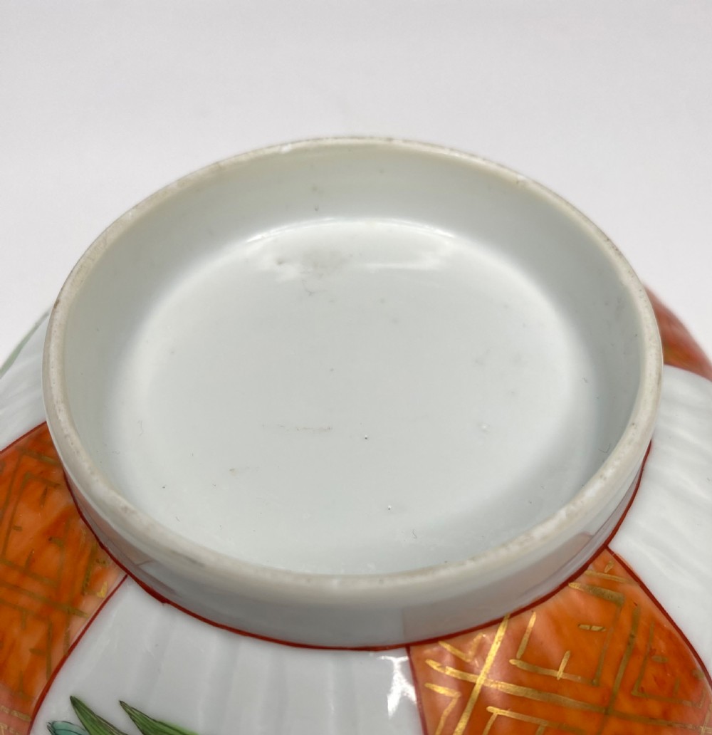 A fluted 18th-century Chinese porcelain bowl decorated in London with alternating panels of orange diaper work and hand-painted figures. View IX