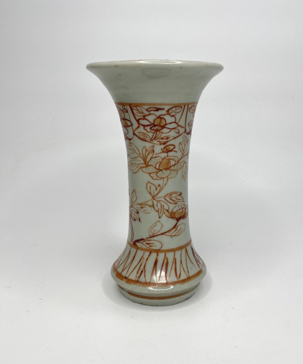 An 18th-century Japanese Arita porcelain beaker vase featuring flared rims and hand-painted iron red floral motifs over a white glaze. View V