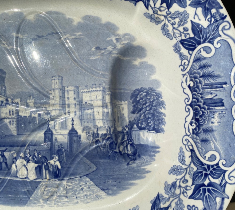 An oval blue and white earthenware meat platter featuring an underglaze transferware illustration of Windsor Castle framed by an ivy leaf border. View VIII