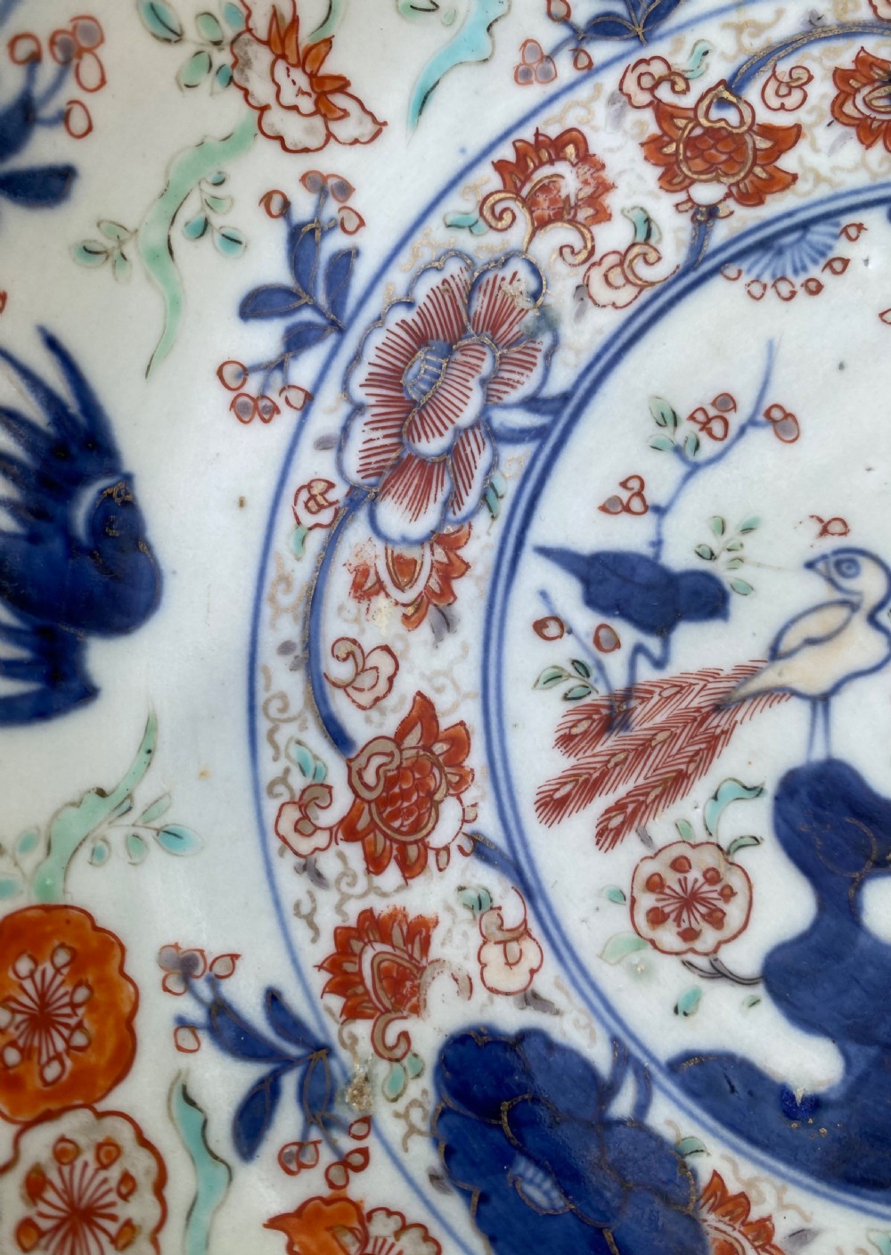 An 18th-century circular Japanese Imari porcelain dish featuring underglaze cobalt blue and overglaze iron-red floral and bird patterns. View VIII