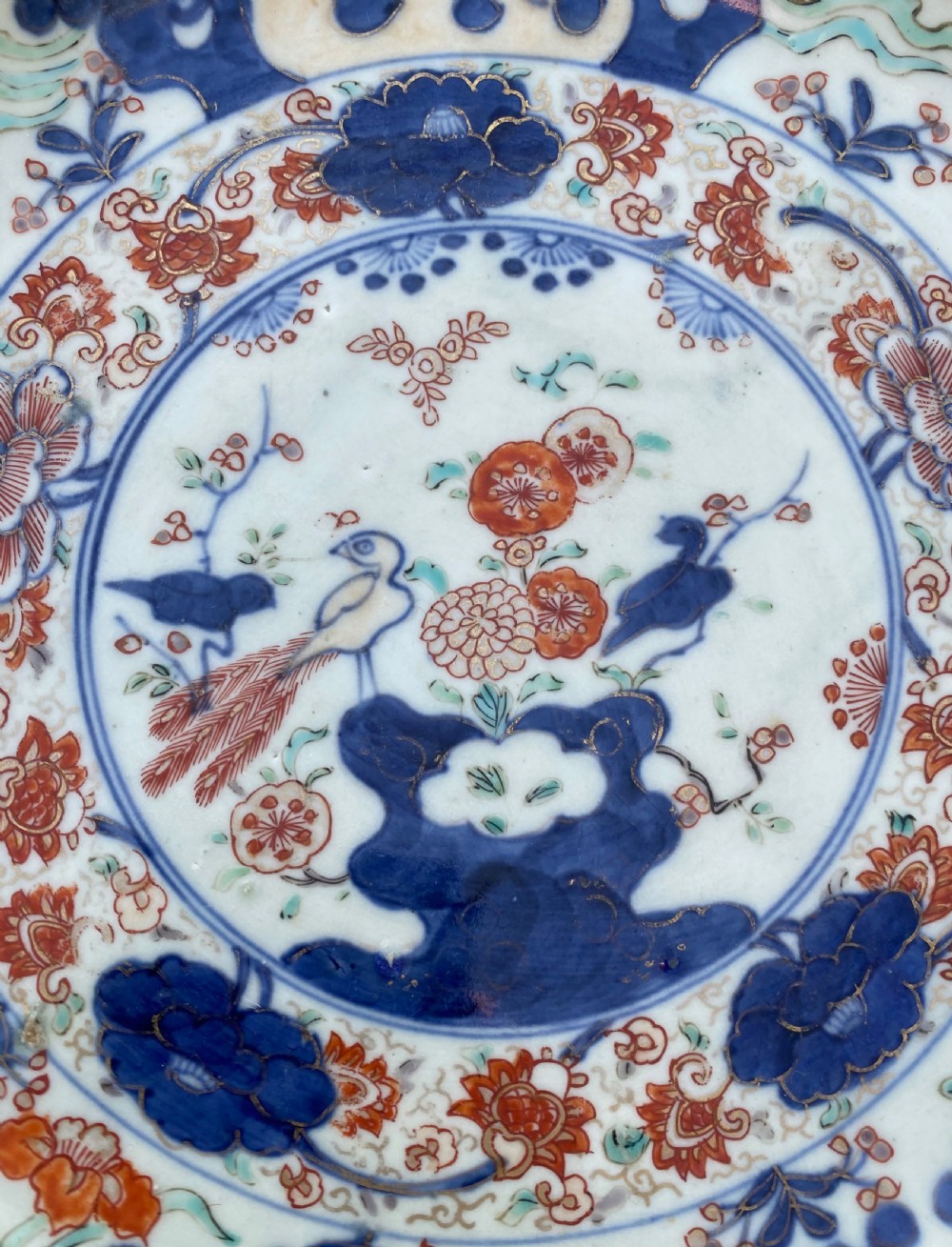An 18th-century circular Japanese Imari porcelain dish featuring underglaze cobalt blue and overglaze iron-red floral and bird patterns. View IX