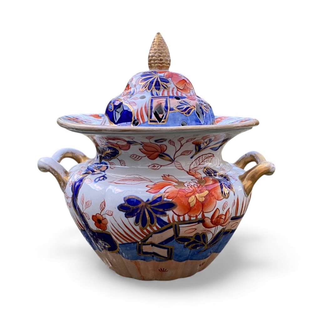 An antique Masons ironstone pot pourri urn featuring twin side handles, a pierced dome lid with a pinecone finial, and hand-painted Imari floral motifs in cobalt blue, rust red, and gold.