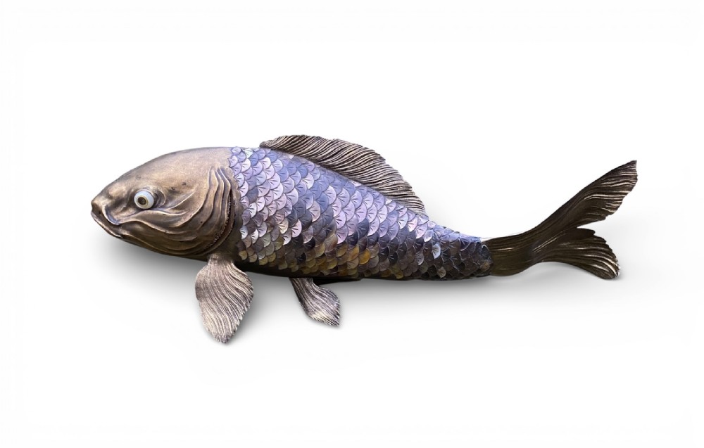 A Meiji period Japanese okimono depicting a carp with iridescent mother-of-pearl scales, detailed fins, and realistic inset eyes.