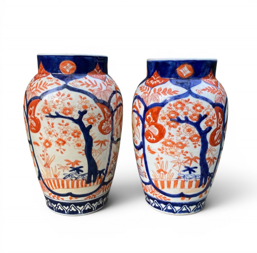 A pair of Japanese Imari porcelain baluster-shaped vases decorated with hand-painted floral patterns in cobalt blue and iron-red enamel on a white ground. View III
