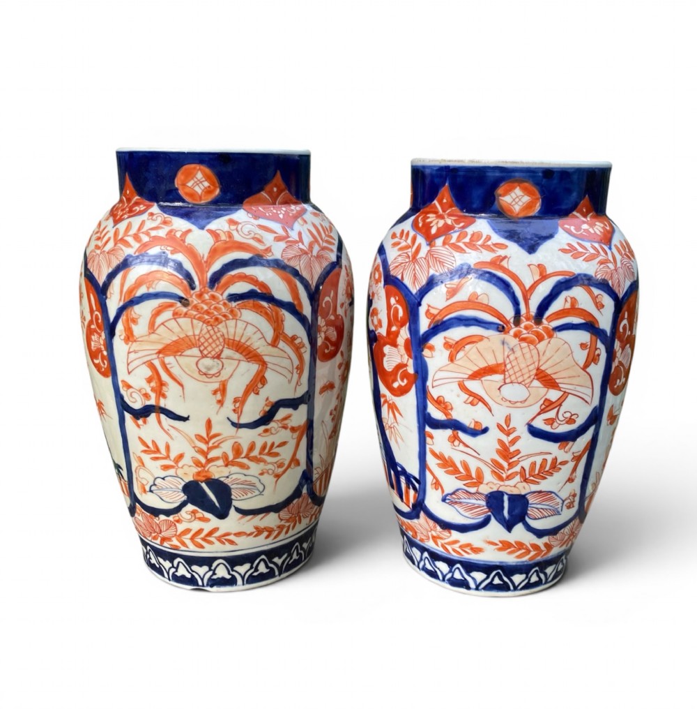 A pair of Japanese Imari porcelain baluster-shaped vases decorated with hand-painted floral patterns in cobalt blue and iron-red enamel on a white ground. View IV