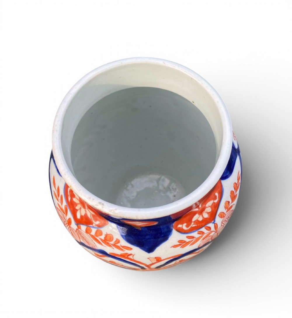 A pair of Japanese Imari porcelain baluster-shaped vases decorated with hand-painted floral patterns in cobalt blue and iron-red enamel on a white ground. View V