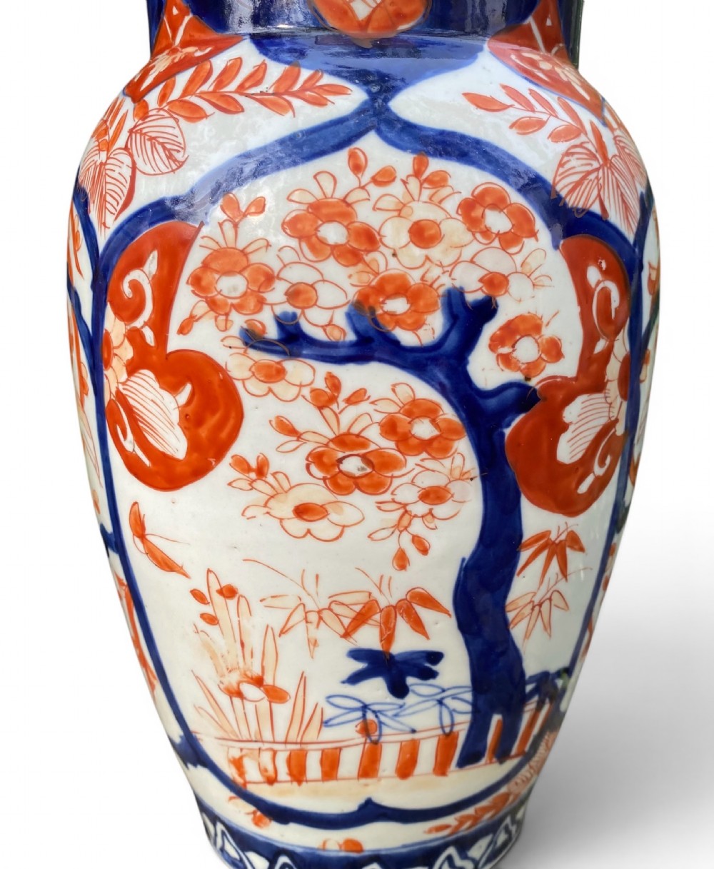 A pair of Japanese Imari porcelain baluster-shaped vases decorated with hand-painted floral patterns in cobalt blue and iron-red enamel on a white ground. View VII