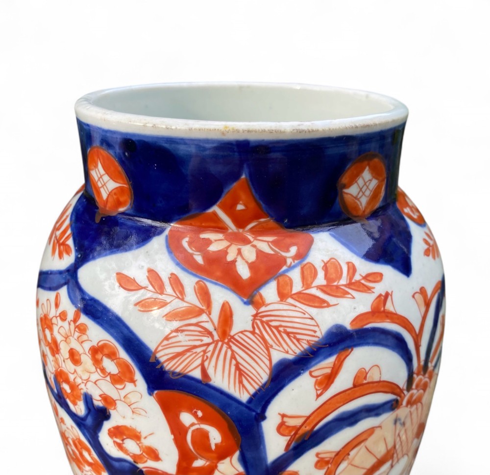 A pair of Japanese Imari porcelain baluster-shaped vases decorated with hand-painted floral patterns in cobalt blue and iron-red enamel on a white ground. View VIII